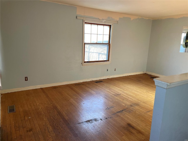 unfurnished room featuring hardwood / wood-style flooring