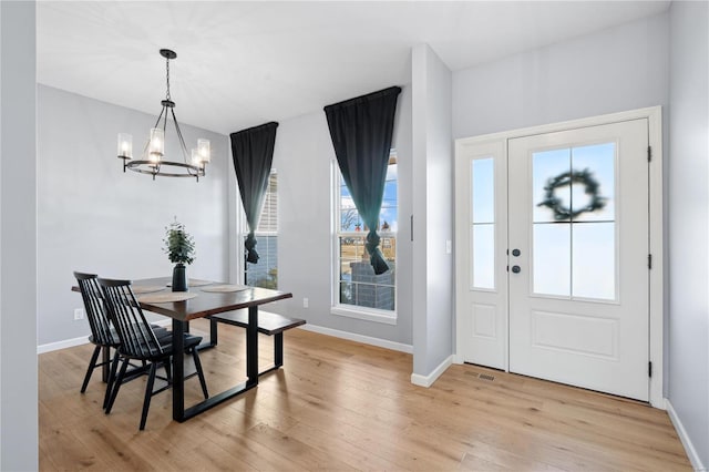 foyer with a chandelier and light hardwood / wood-style floors