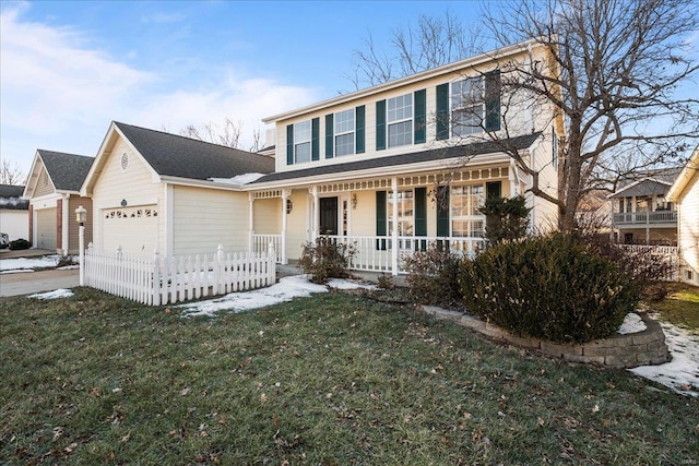 view of property featuring a garage, a porch, and a front yard