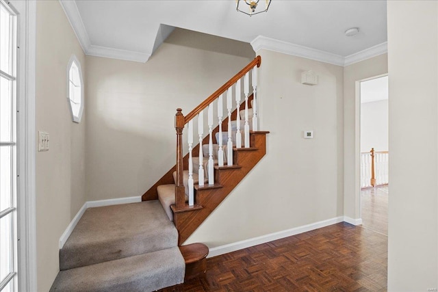 stairs featuring parquet floors and ornamental molding