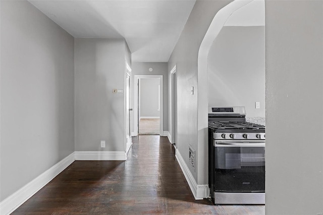 kitchen with dark wood-type flooring and stainless steel range with gas cooktop