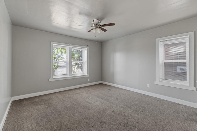 carpeted spare room with ceiling fan