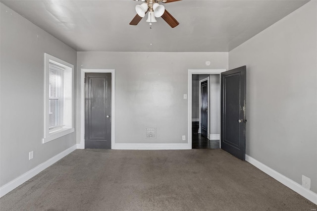 carpeted empty room featuring ceiling fan