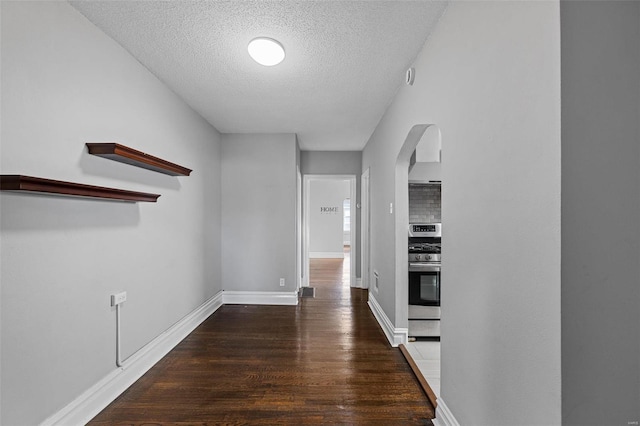 hall featuring dark hardwood / wood-style floors and a textured ceiling