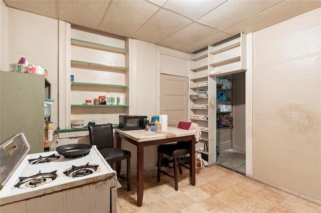 dining area featuring a drop ceiling