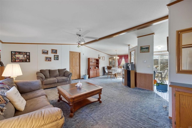 carpeted living room with lofted ceiling with beams, ornamental molding, ceiling fan with notable chandelier, and wooden walls