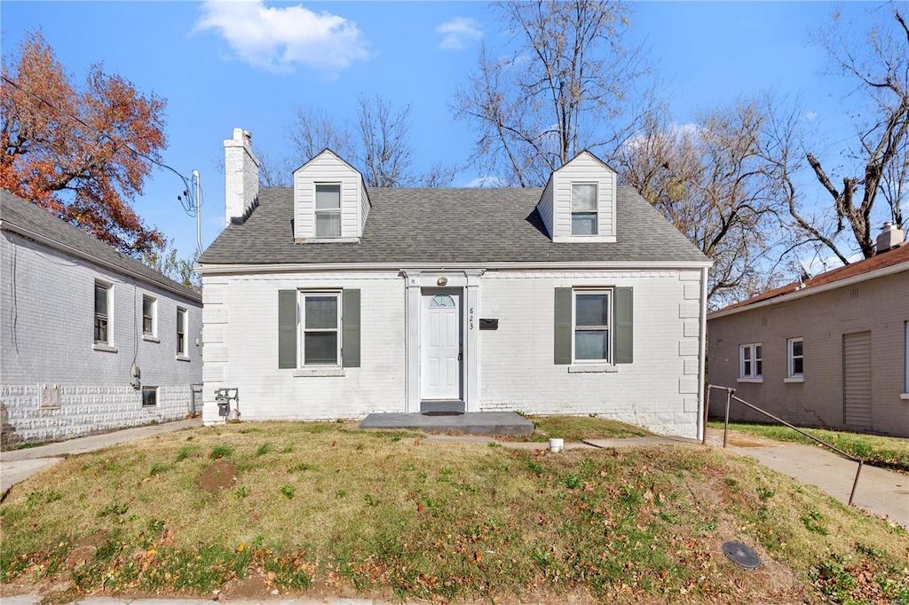 cape cod-style house with a front yard