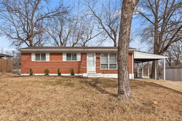 single story home with a carport, a front yard, concrete driveway, and brick siding