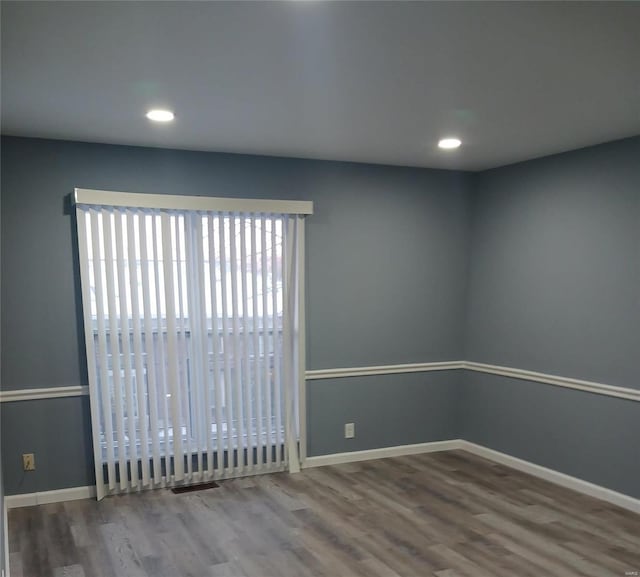 unfurnished room featuring hardwood / wood-style floors