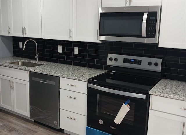 kitchen with white cabinetry, range with electric cooktop, dishwasher, and sink