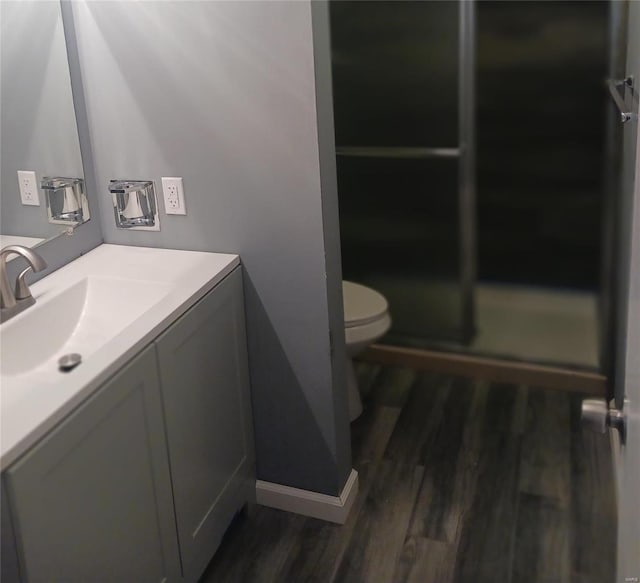 bathroom with vanity, an enclosed shower, wood-type flooring, and toilet