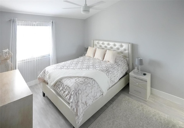 bedroom with ceiling fan and light wood-type flooring