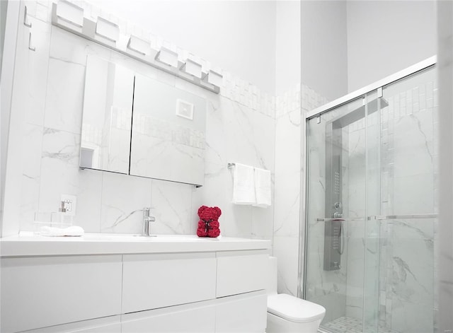 bathroom featuring vanity, an enclosed shower, and toilet