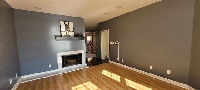 unfurnished living room with wood-type flooring