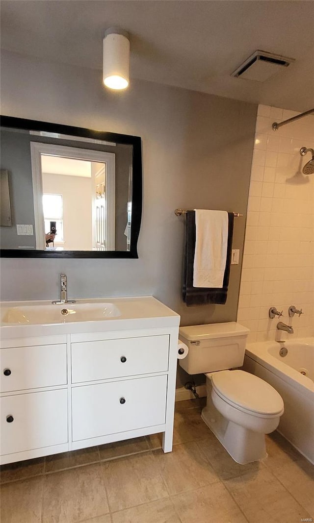 full bathroom with tiled shower / bath combo, vanity, and toilet