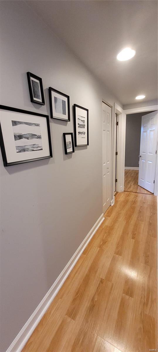 corridor with light hardwood / wood-style flooring