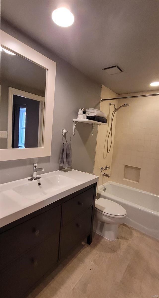 full bathroom with vanity, toilet, and tiled shower / bath