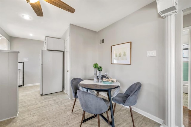 dining area with ceiling fan, light hardwood / wood-style flooring, and ornate columns