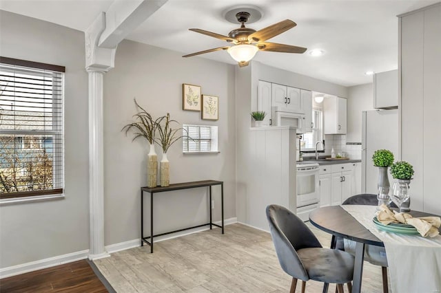 dining space with sink, plenty of natural light, and ceiling fan