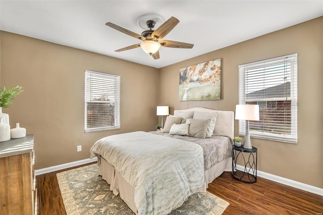 bedroom with ceiling fan and dark hardwood / wood-style flooring