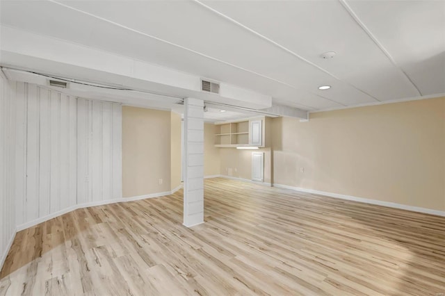 basement with light hardwood / wood-style flooring