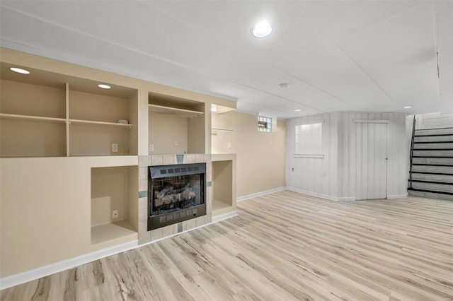 unfurnished living room featuring a fireplace and light hardwood / wood-style flooring