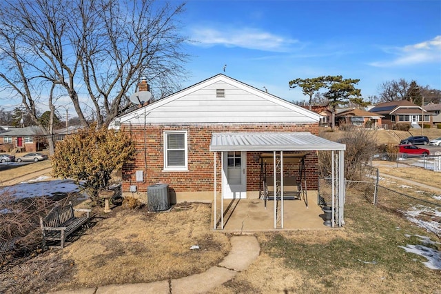 rear view of house with central AC unit and a patio area