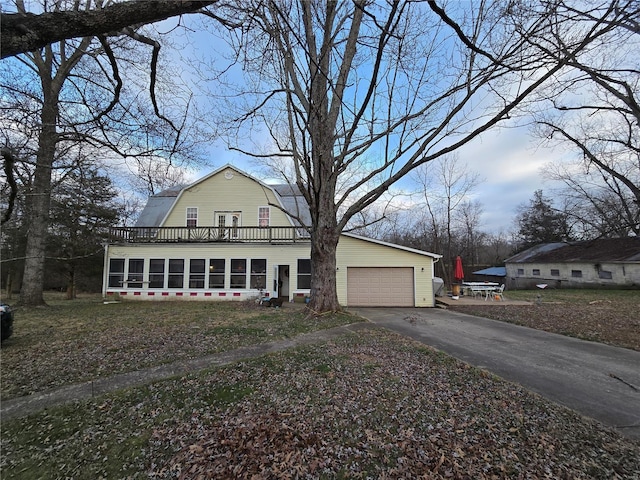 view of front of home with a garage and a sunroom