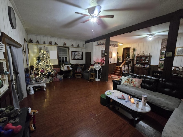 living room featuring ceiling fan, dark hardwood / wood-style flooring, and a textured ceiling