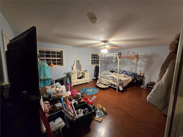 bedroom with hardwood / wood-style flooring and ceiling fan