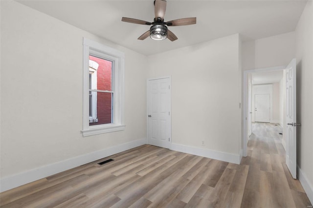 unfurnished room featuring ceiling fan and light hardwood / wood-style floors