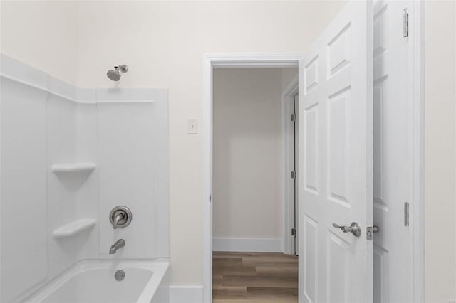 bathroom with shower / washtub combination and wood-type flooring