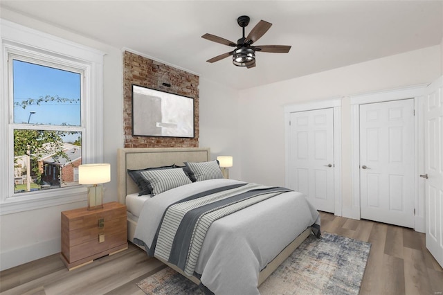 bedroom with ceiling fan and light wood-type flooring