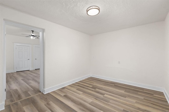 empty room featuring light hardwood / wood-style flooring and a textured ceiling