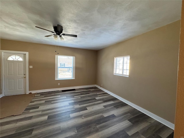 entrance foyer featuring ceiling fan, dark hardwood / wood-style floors, and a textured ceiling