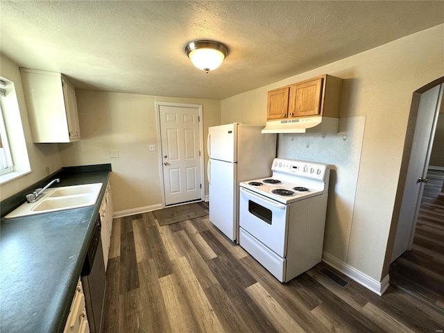 kitchen featuring dark hardwood / wood-style flooring, sink, a textured ceiling, and white appliances