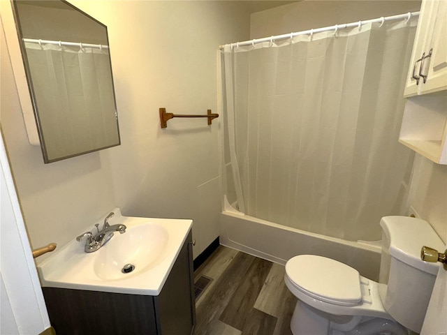 full bathroom with vanity, hardwood / wood-style floors, toilet, and shower / tub combo with curtain