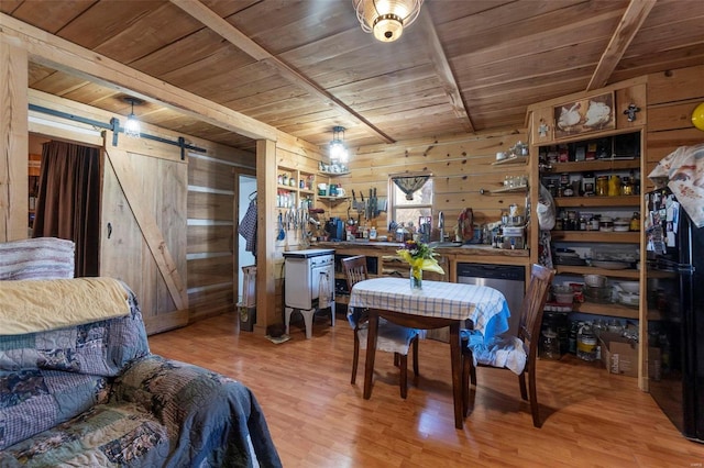 dining area featuring wood walls, light wood-type flooring, wooden ceiling, beamed ceiling, and a barn door