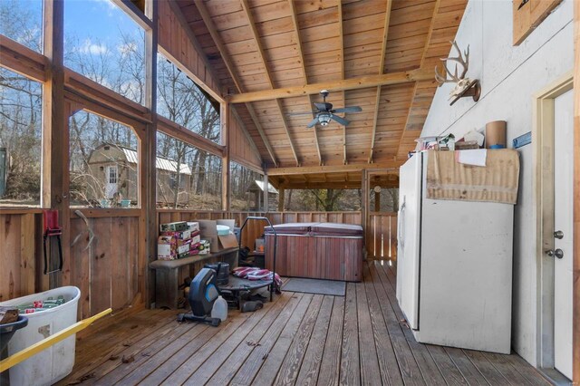 unfurnished sunroom featuring vaulted ceiling with beams, wooden ceiling, and ceiling fan