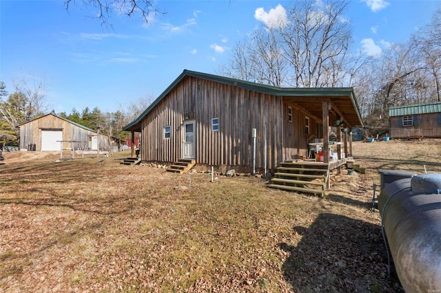 view of side of property with a garage and an outbuilding