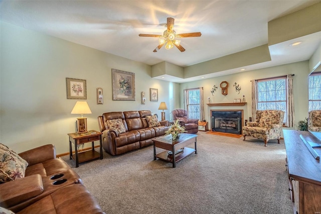 carpeted living room featuring ceiling fan and a wealth of natural light