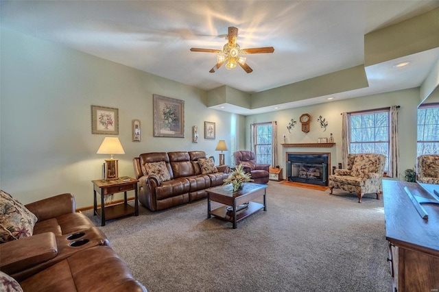 living room with ceiling fan and carpet flooring