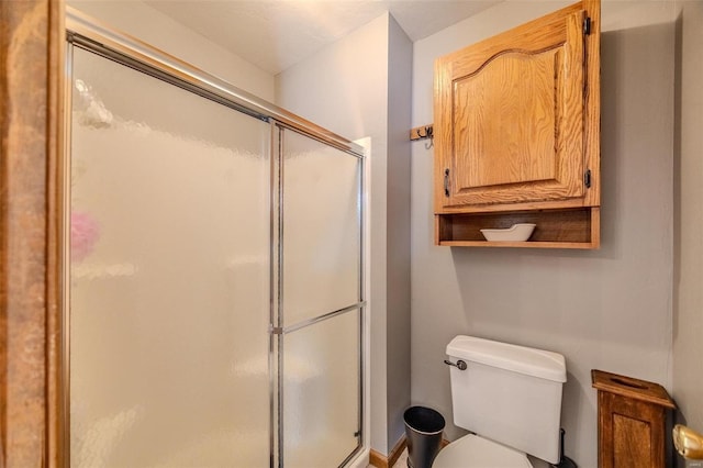 bathroom with toilet and walk in shower