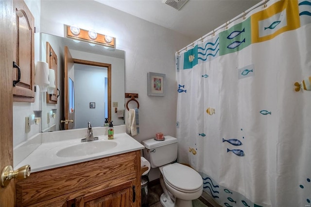 bathroom featuring vanity, toilet, and a shower with shower curtain