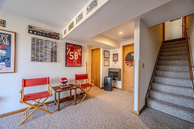 living area with carpet flooring and heating unit