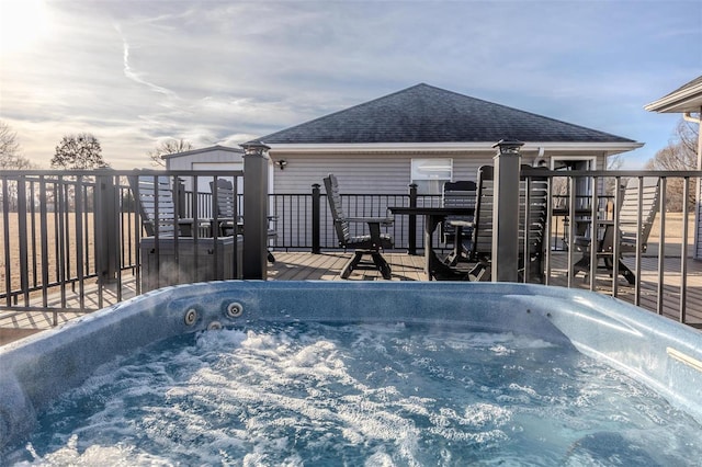 wooden terrace featuring a hot tub