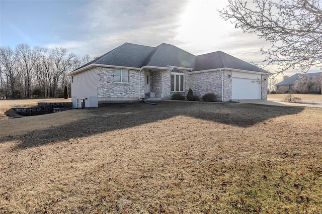 view of front of property featuring a garage and a front lawn