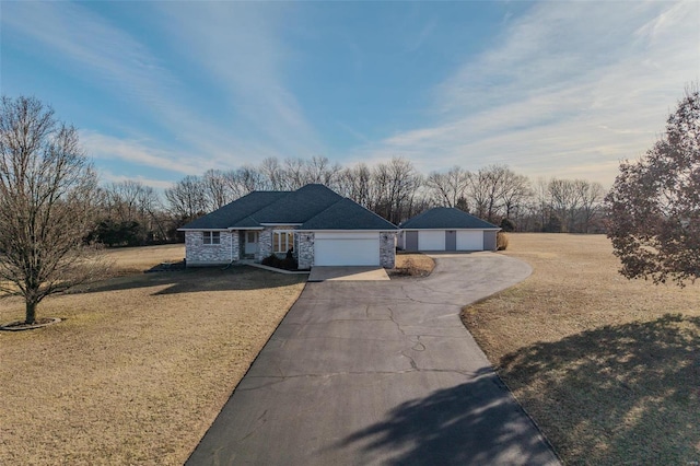 ranch-style home with a garage and a front yard