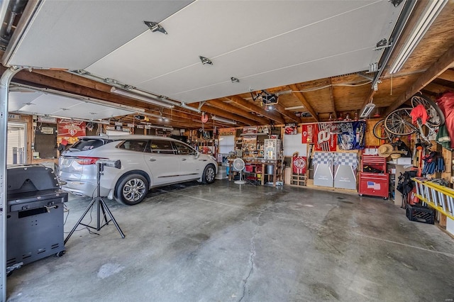 garage with a garage door opener and a workshop area