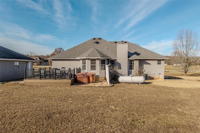 back of house featuring a wooden deck and a yard